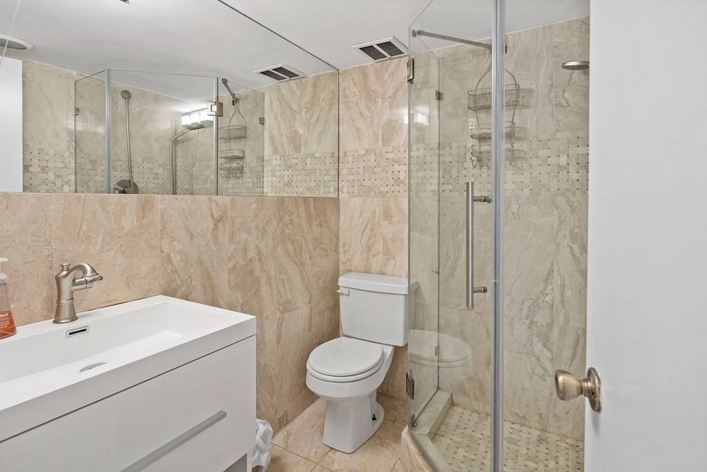 338 Beacon Street, Unit A Boston, MA 02116 - Photo 15 of 17 a bathroom with a toilet sink vanity and shower
