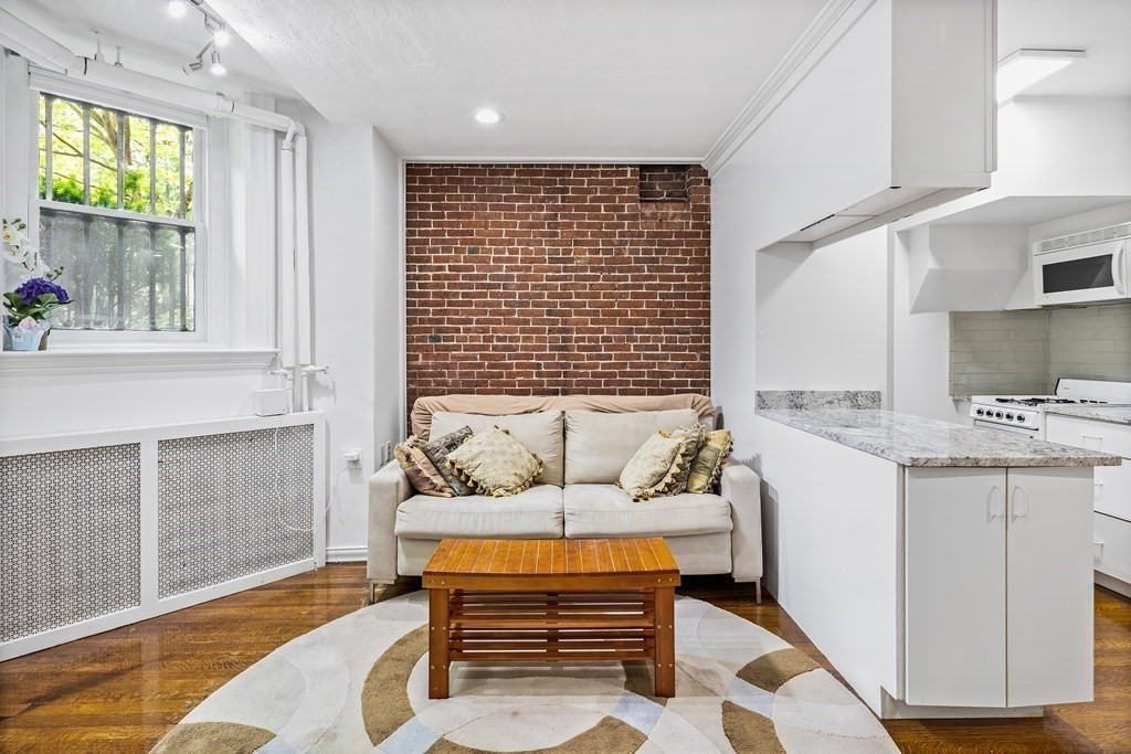 338 Beacon Street, Unit A Boston, MA 02116 - Photo 6 of 17 a living room with furniture and wooden floor