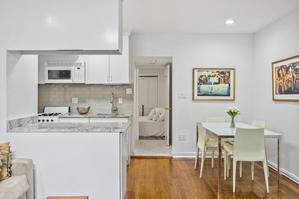 338 Beacon Street, Unit A Boston, MA 02116 - Photo 7 of 17 a view of a kitchen with a table and chairs