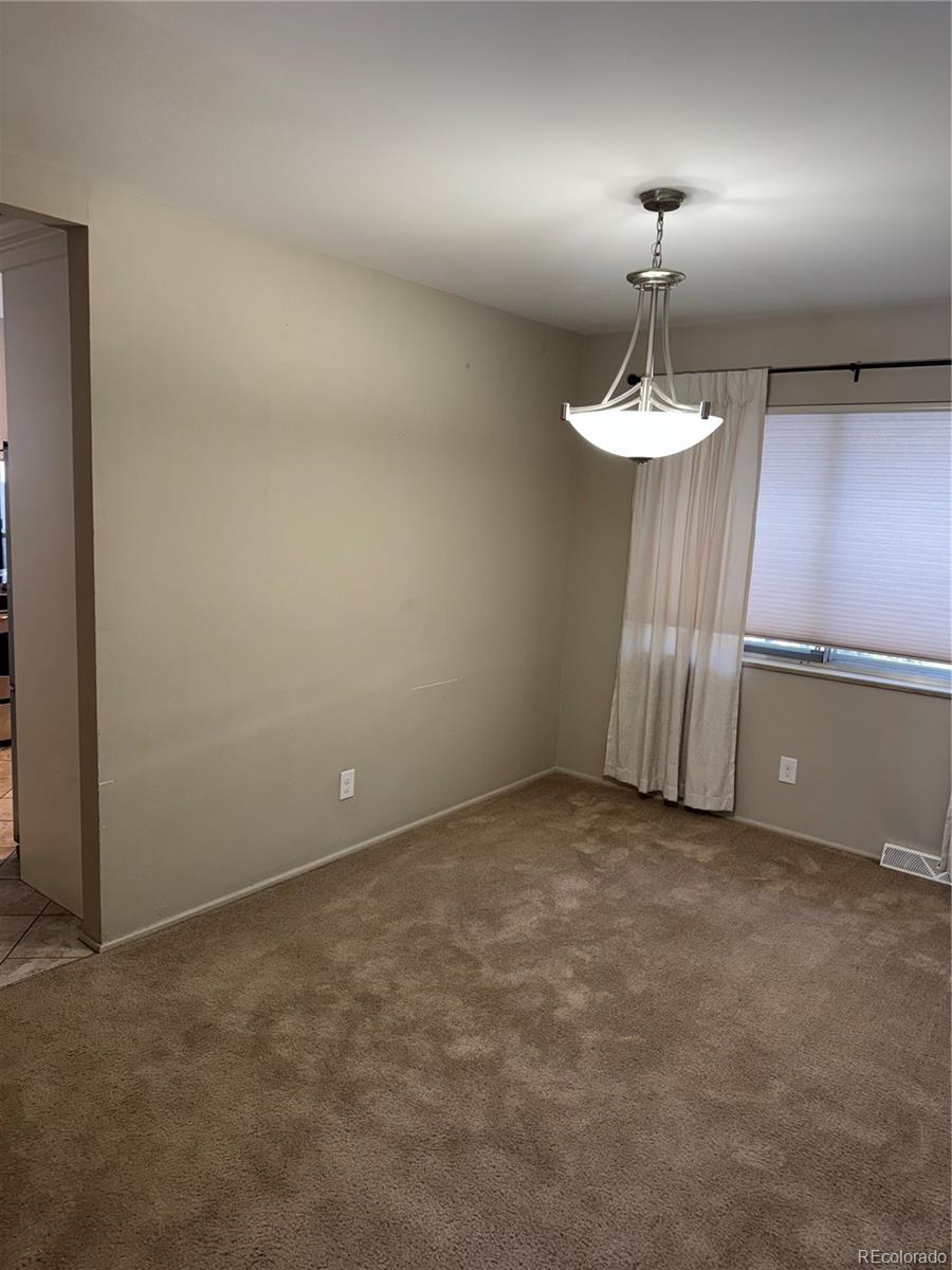 2524 South Oneida Street Denver, CO 80224 - Photo 1 of 11 an empty room with a chandelier fan