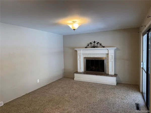 a view of an empty room with a fireplace