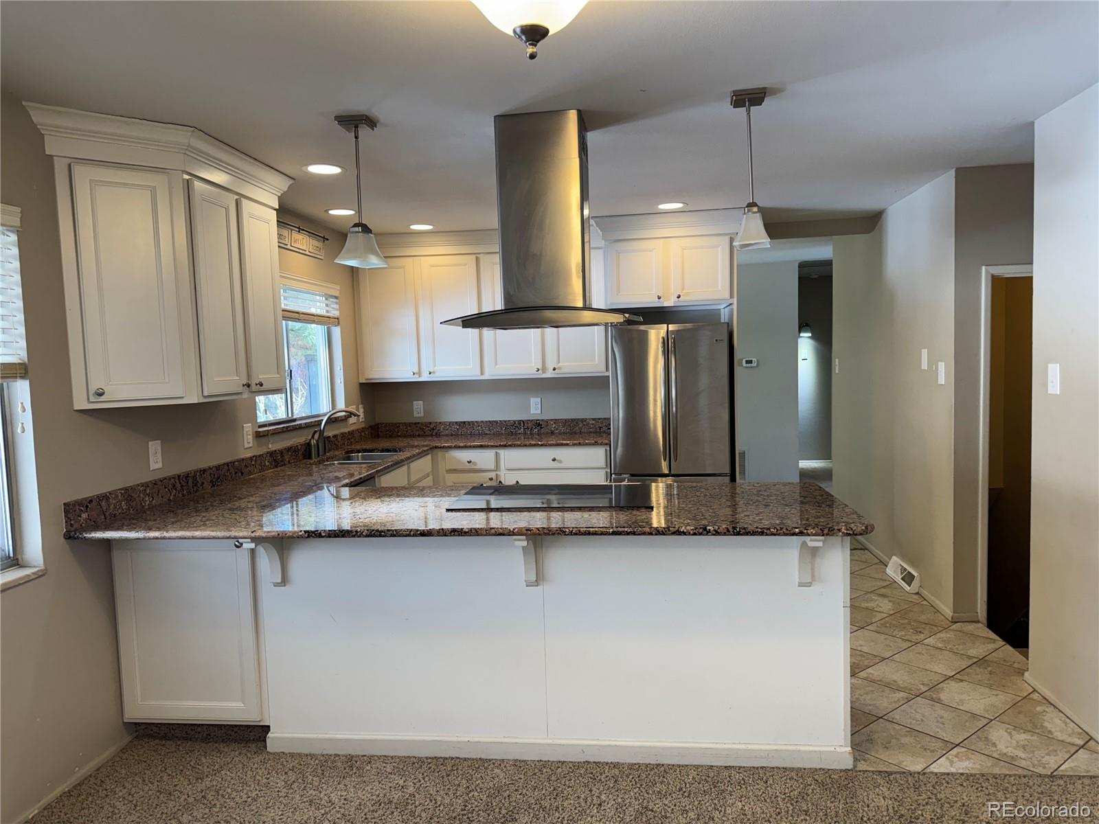 2524 South Oneida Street Denver, CO 80224 - Photo 4 of 11 a kitchen with stainless steel appliances granite countertop a sink a stove and a refrigerator