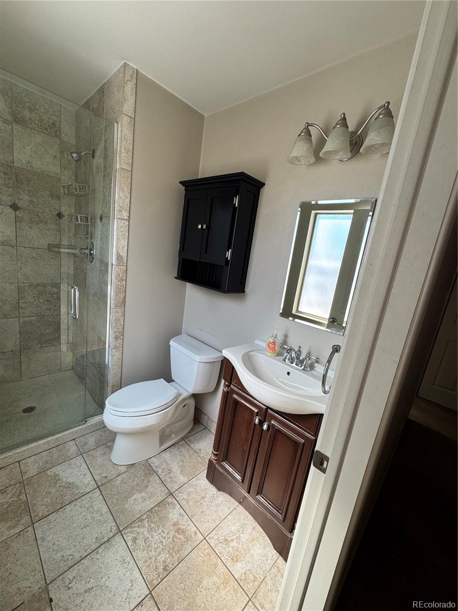 2524 South Oneida Street Denver, CO 80224 - Photo 7 of 11 a bathroom with a toilet sink and shower