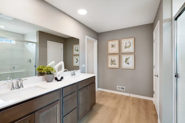a bathroom with a sink double vanity and a mirror