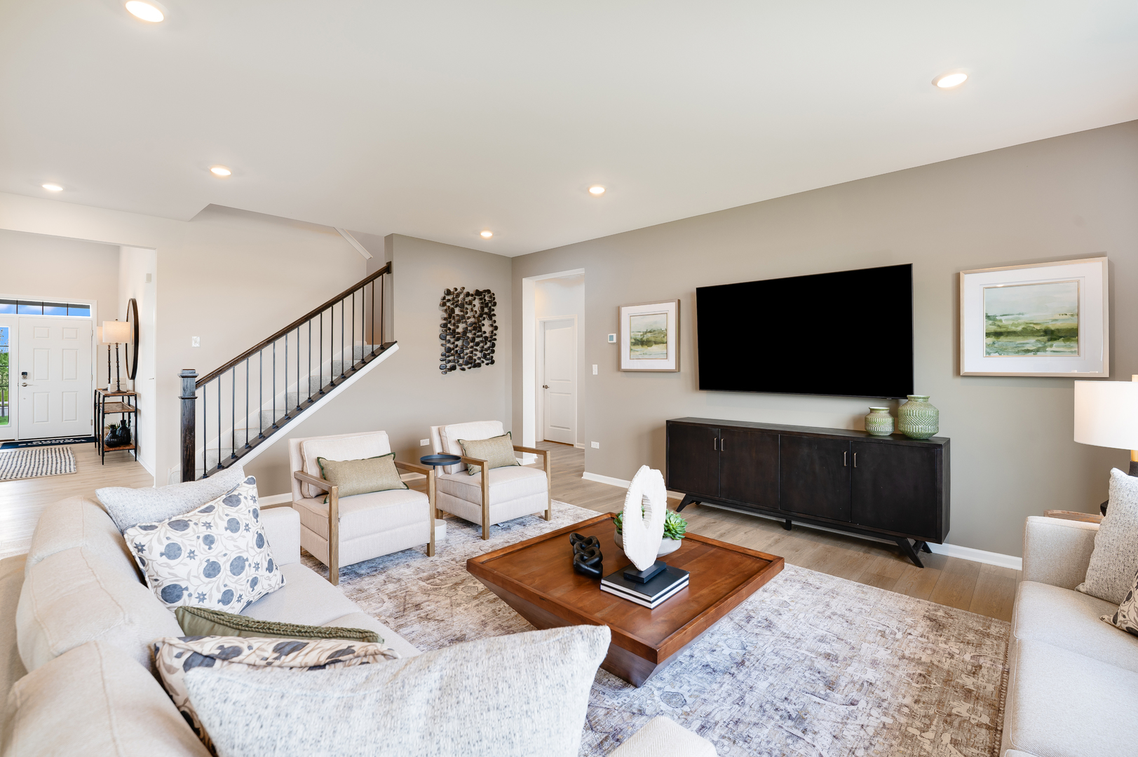 115 Henderson Street Oswego, IL 60543 - Photo 4 of 20 a living room with furniture and a flat screen tv