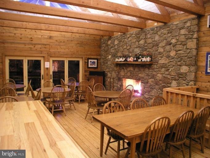 2747 Leeds Manor Road Markham, VA 22643 - Photo 4 of 5 a view of a patio with table and chairs with wooden floor
