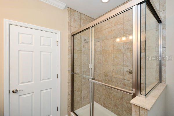 4212 Expedition Way Osprey, FL 34229 - Photo 18 of 28 a bathroom with a glass shower door