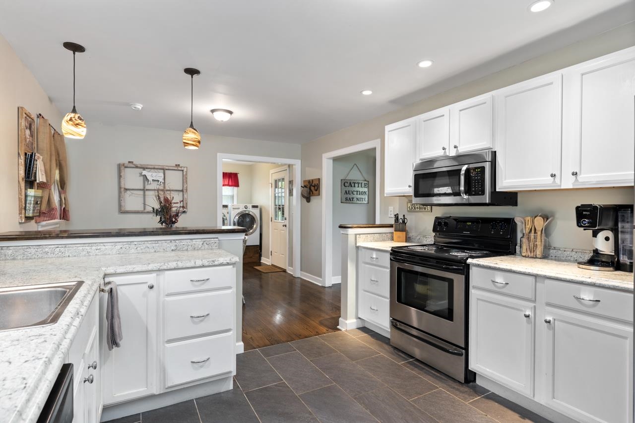376 Kiddsville Road Fishersville, VA 22939 - Photo 9 of 31 a kitchen with white cabinets and stainless steel appliances