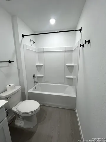 a view of small yard with wooden fence