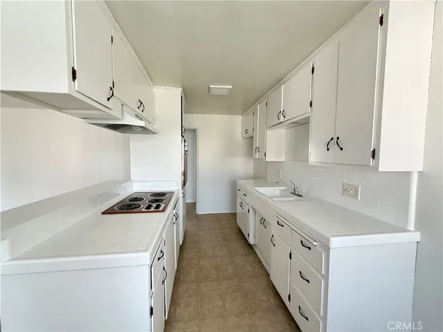 a kitchen with cabinets a sink and appliances