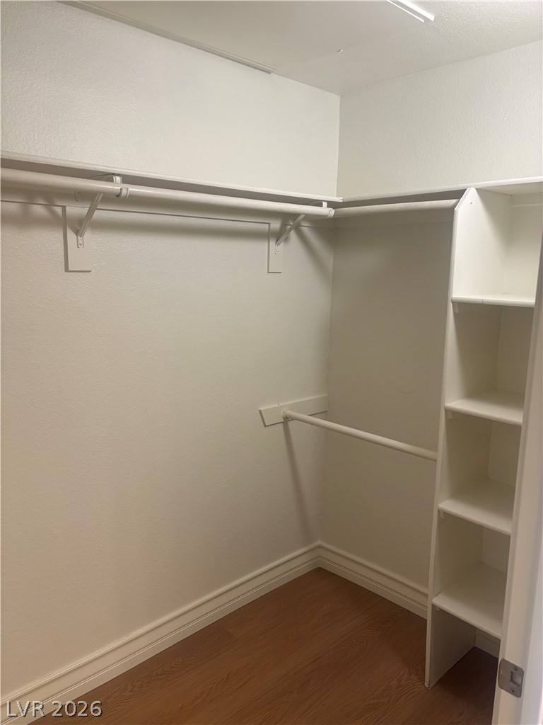 210 East Flamingo Road, Unit 123 Las Vegas, NV 89169 - Photo 12 of 17 Rich wood flooring pairs with integrated shelving in this organized walk-in closet.