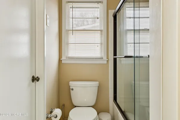 a bathroom with a sink and mirror with toilet