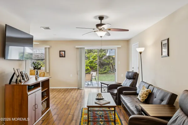 a living room with furniture and wooden floor