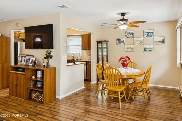 a view of a dining room with furniture and wooden floor