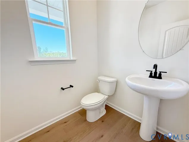 a bedroom with furniture and wooden floor