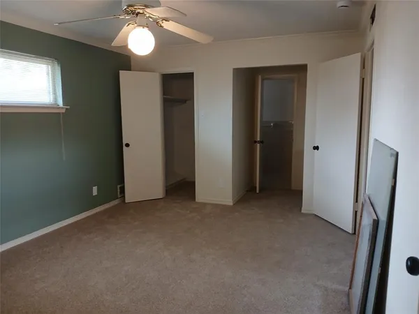 an empty room that has a mirror in it