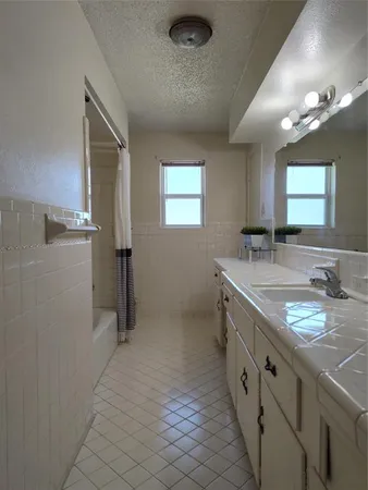 a bathroom with double sink and a mirror