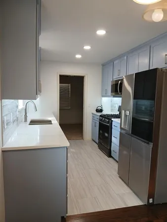 a kitchen with a sink stainless steel appliances and cabinets