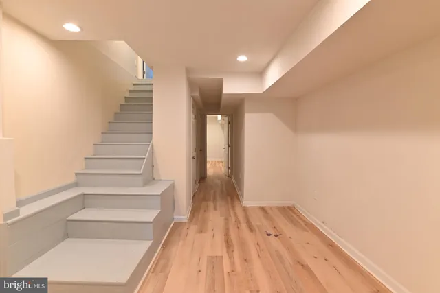a view of entryway and hall with wooden floor
