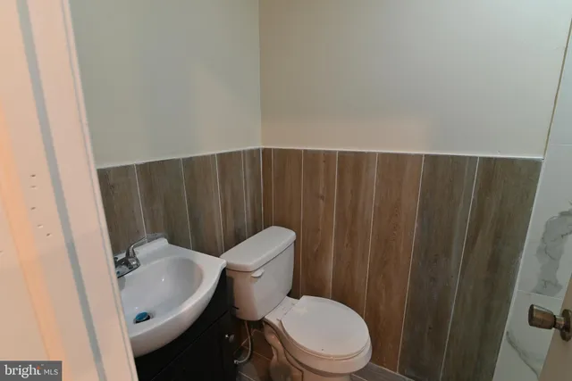 a white toilet sitting next to a bathroom sink