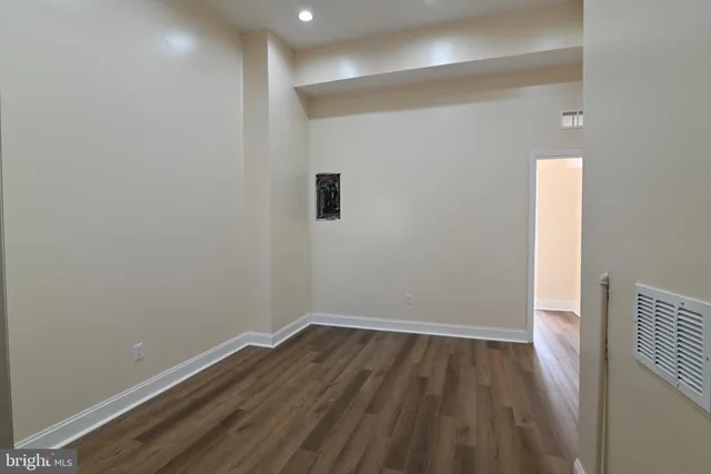 a view of a room with wooden floor