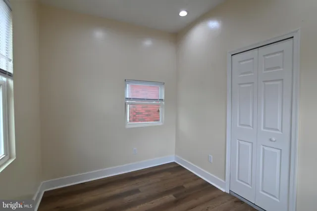 an empty room with wooden floor