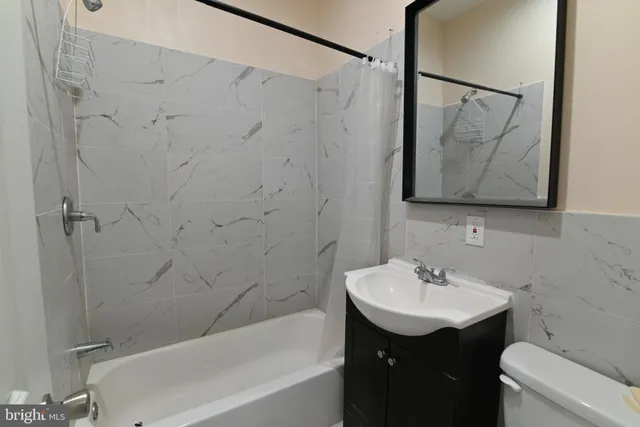a bathroom with a sink vanity and toilet