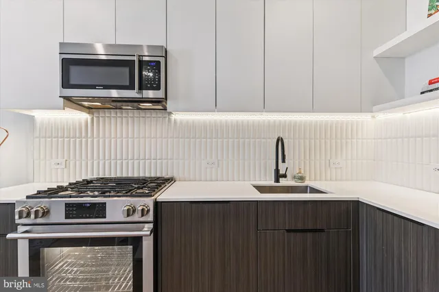 a kitchen with a stove and a microwave