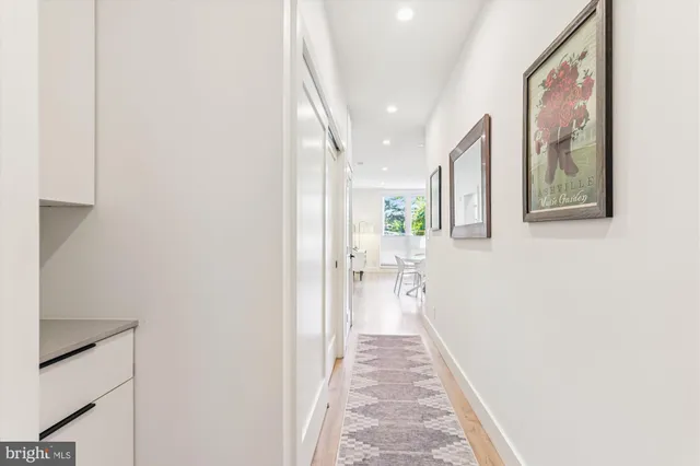 a hallway with a large mirror and a window