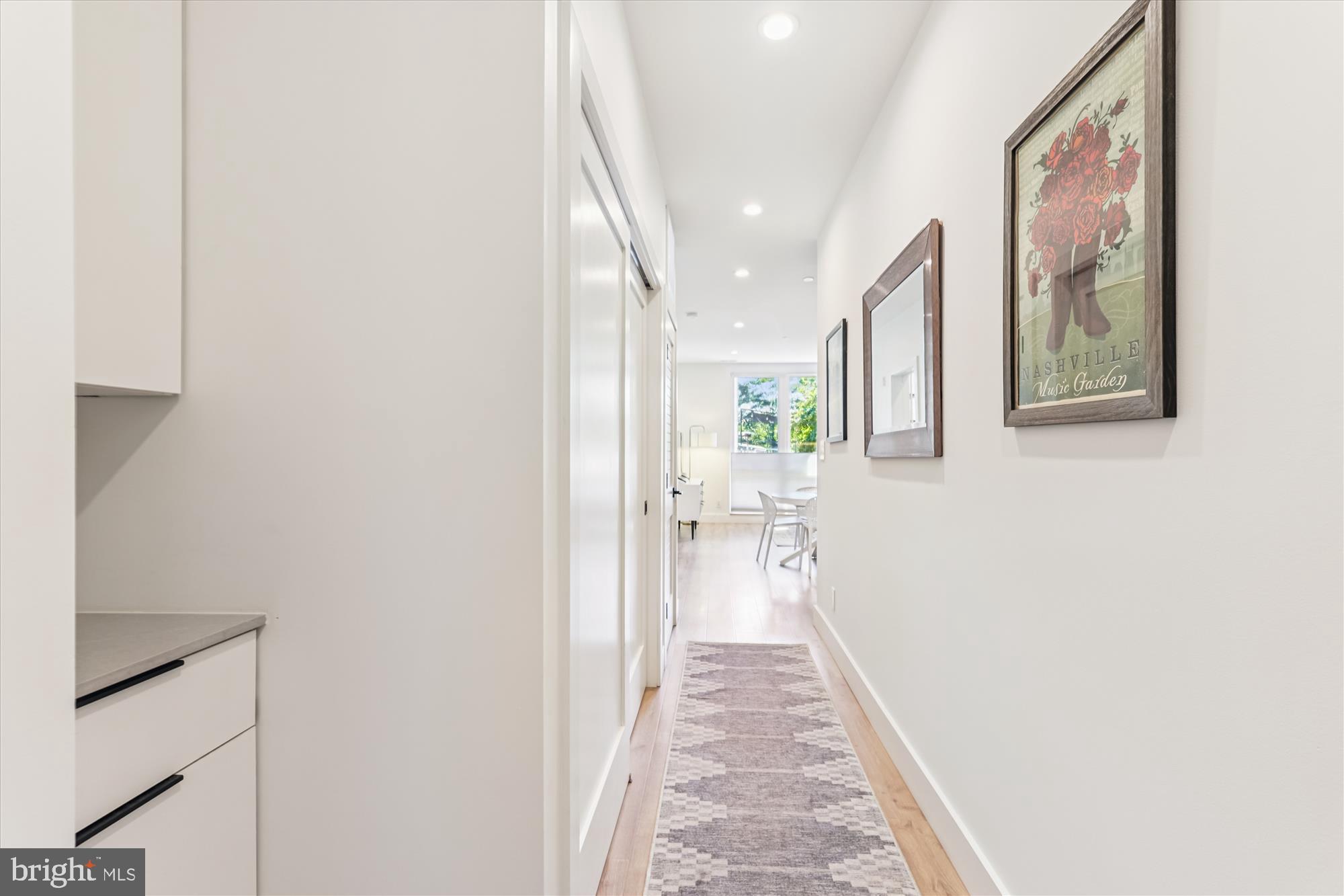 3117 Georgia Avenue Northwest, Unit 102 Washington, DC 20010 - Photo 13 of 30 a hallway with a large mirror and a window