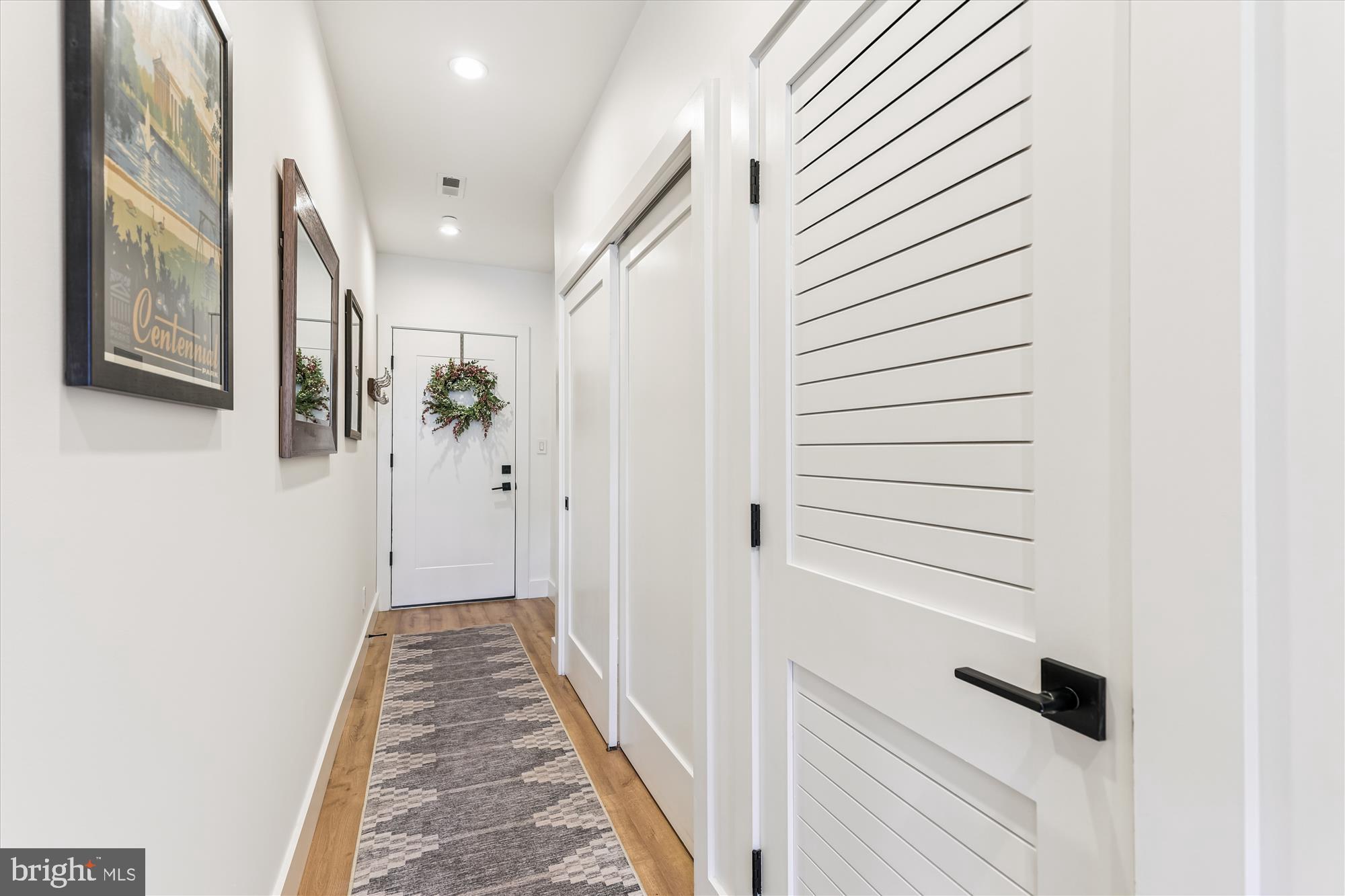 3117 Georgia Avenue Northwest, Unit 102 Washington, DC 20010 - Photo 14 of 30 a view of a hallway with wooden floor and staircase