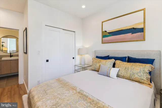 a bedroom with a bed and a painting on the wall