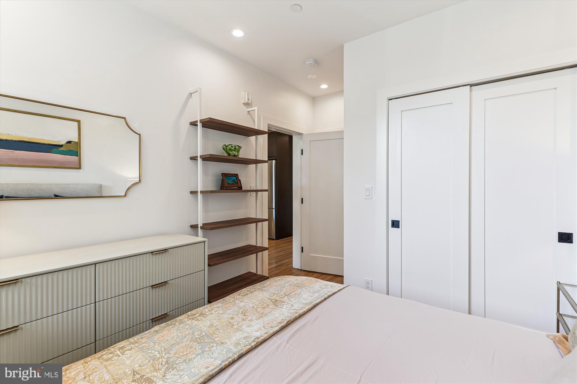 3117 Georgia Avenue Northwest, Unit 102 Washington, DC 20010 - Photo 17 of 30 a bedroom with a bed and a cabinets
