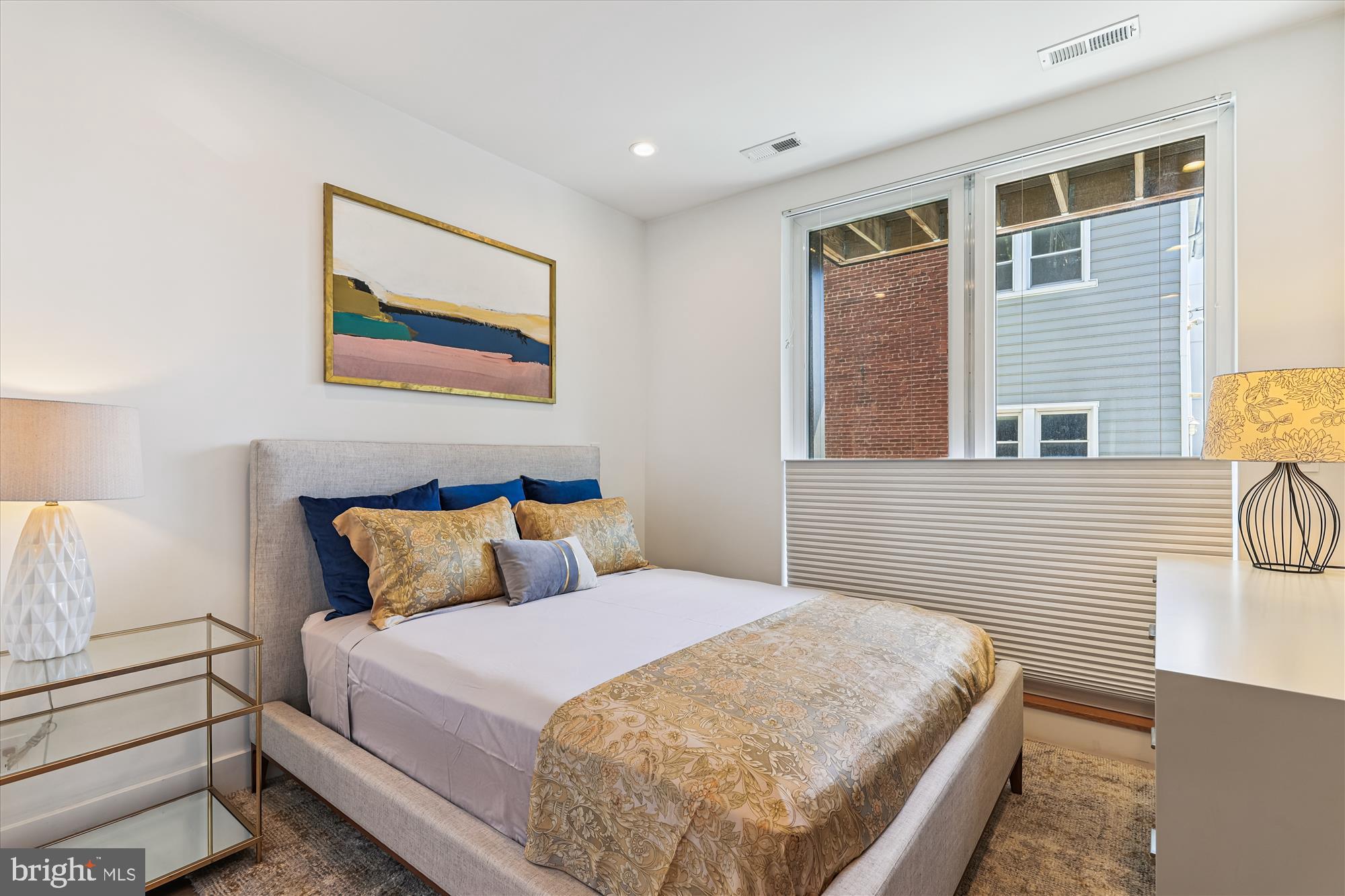 3117 Georgia Avenue Northwest, Unit 102 Washington, DC 20010 - Photo 5 of 30 a bedroom with a bed and wooden floor