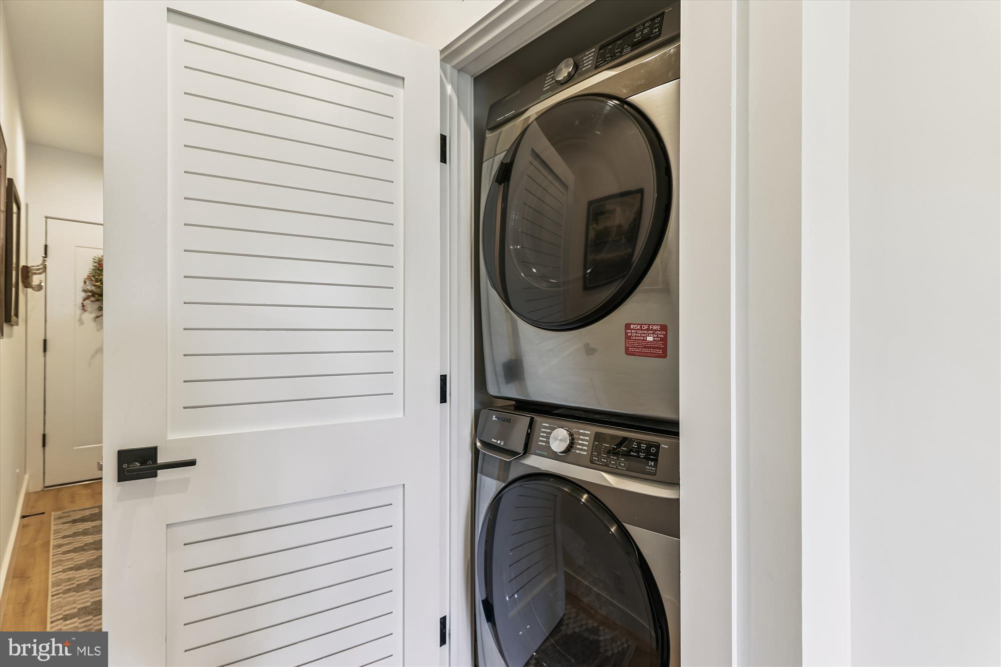 3117 Georgia Avenue Northwest, Unit 102 Washington, DC 20010 - Photo 7 of 30 a view of a hallway with washer and dryer