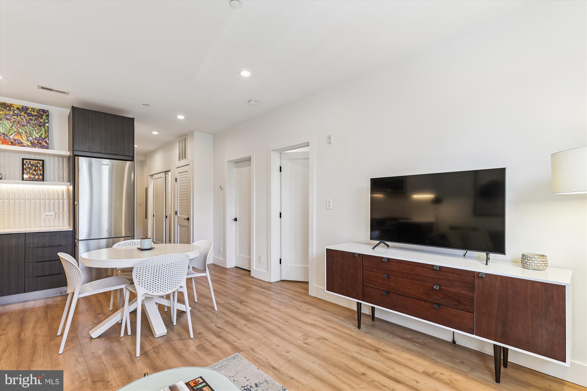 3117 Georgia Avenue Northwest, Unit 102 Washington, DC 20010 - Photo 10 of 30 a living room with furniture and a flat screen tv