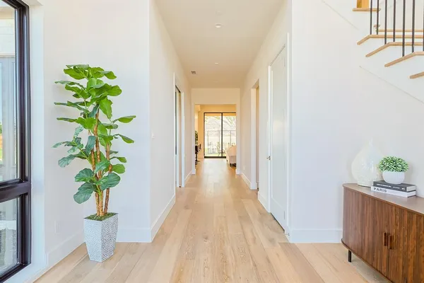 a kitchen with white cabinets a sink and dishwasher