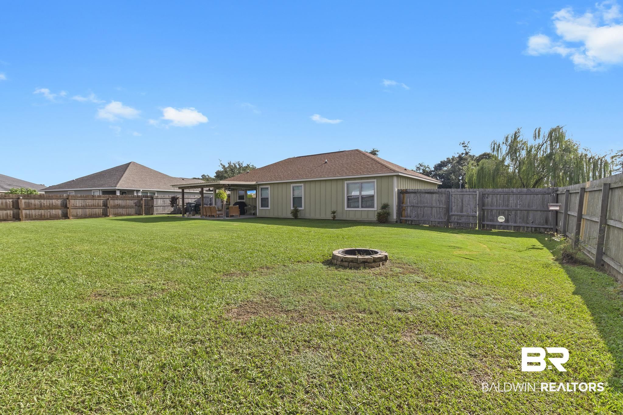 203 Lakefront Circle Summerdale, AL 36580 - Photo 62 of 69 View of yard with a fire pit