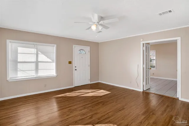 wooden floor in an empty room with a window