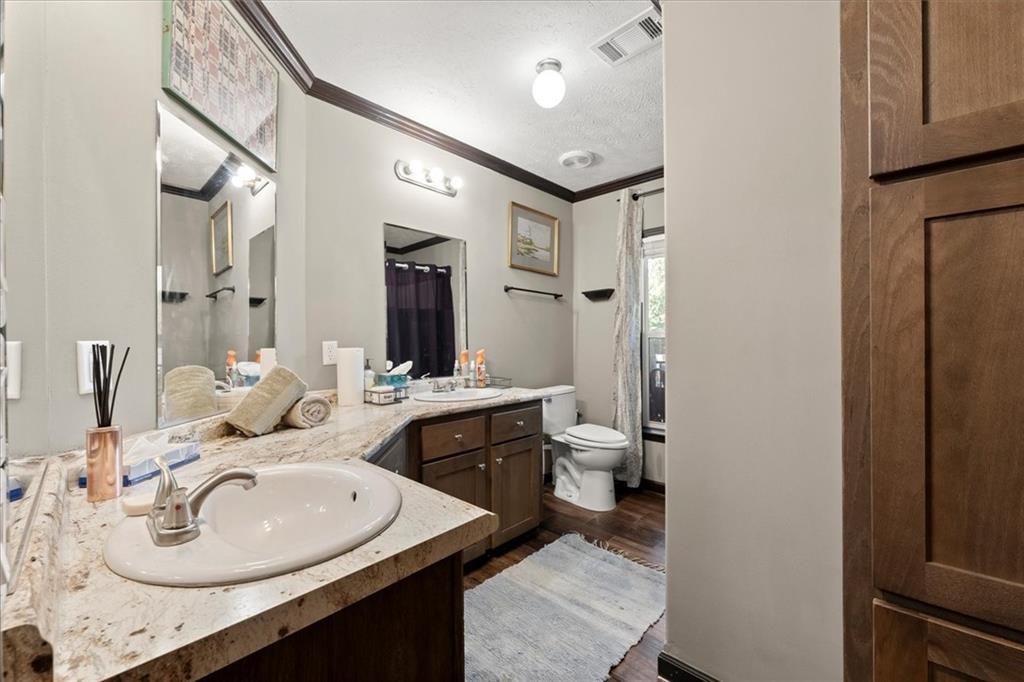 170 Anoia Road Washington, GA 30673 - Photo 21 of 46 a en suite bathroom with a sink double vanity and a mirror