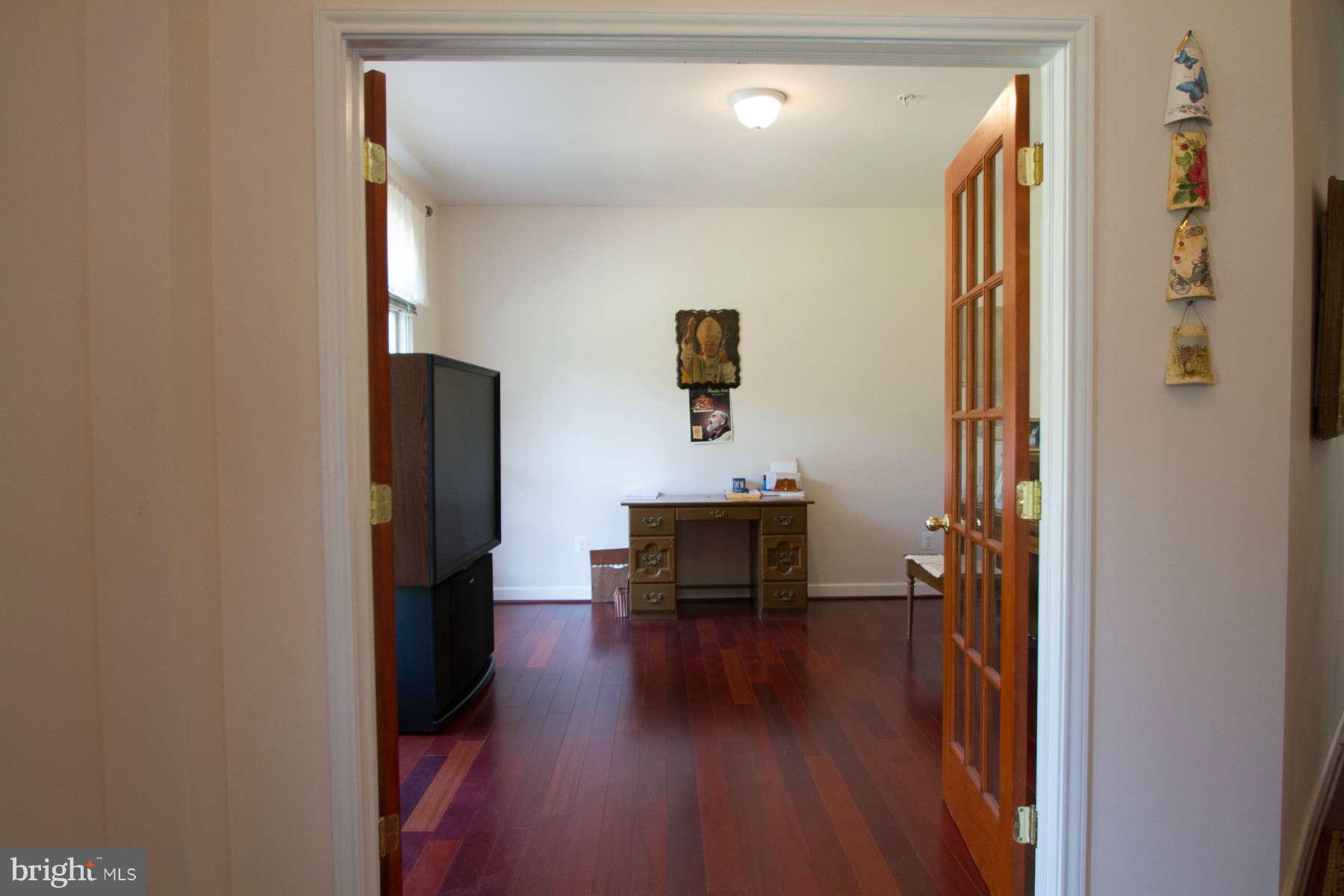 13609 Layhill Road Silver Spring, MD 20906 - Photo 13 of 30 a view of a hallway with wooden floor and furniture