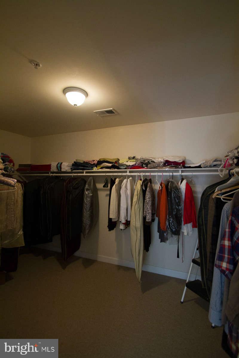 13609 Layhill Road Silver Spring, MD 20906 - Photo 19 of 30 a view of walk in closet with clothes and shoes