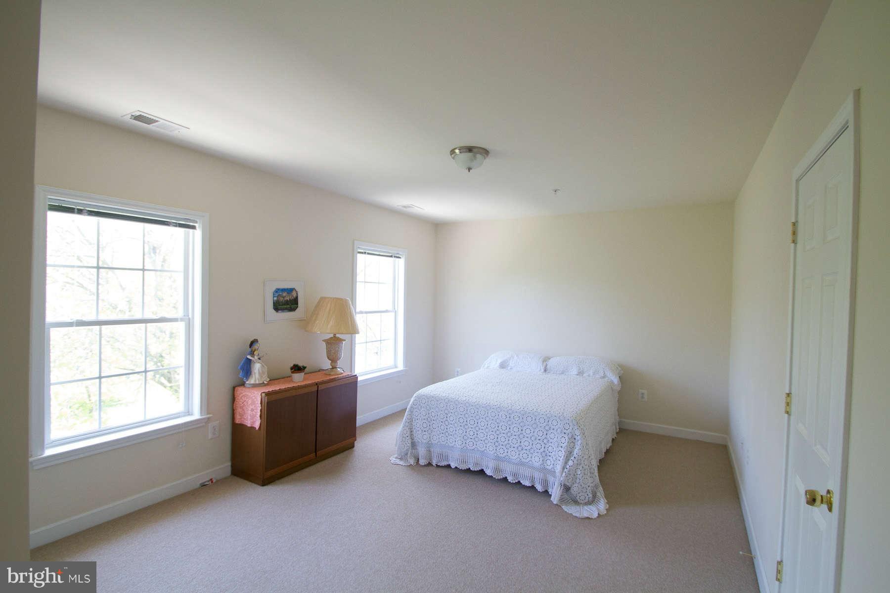 13609 Layhill Road Silver Spring, MD 20906 - Photo 21 of 30 a spacious bedroom with a bed and window