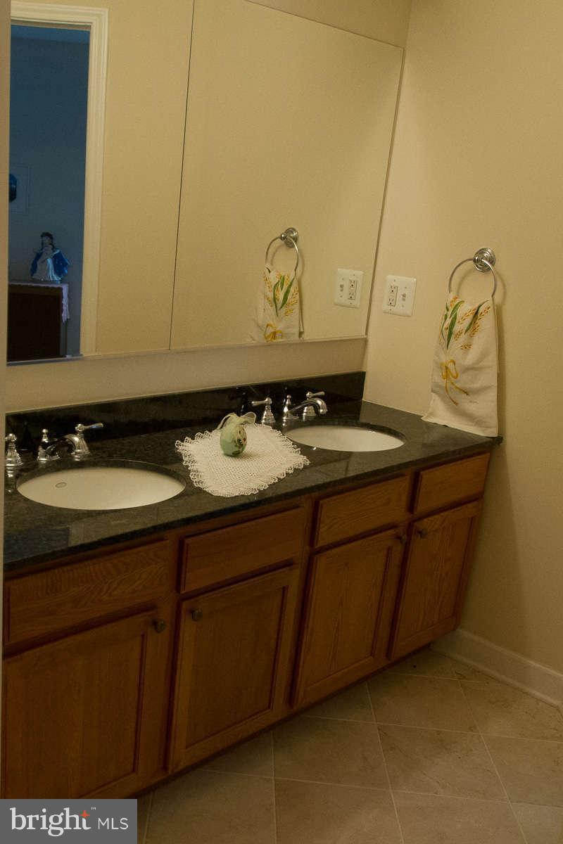 13609 Layhill Road Silver Spring, MD 20906 - Photo 22 of 30 a bathroom with a sink and a mirror
