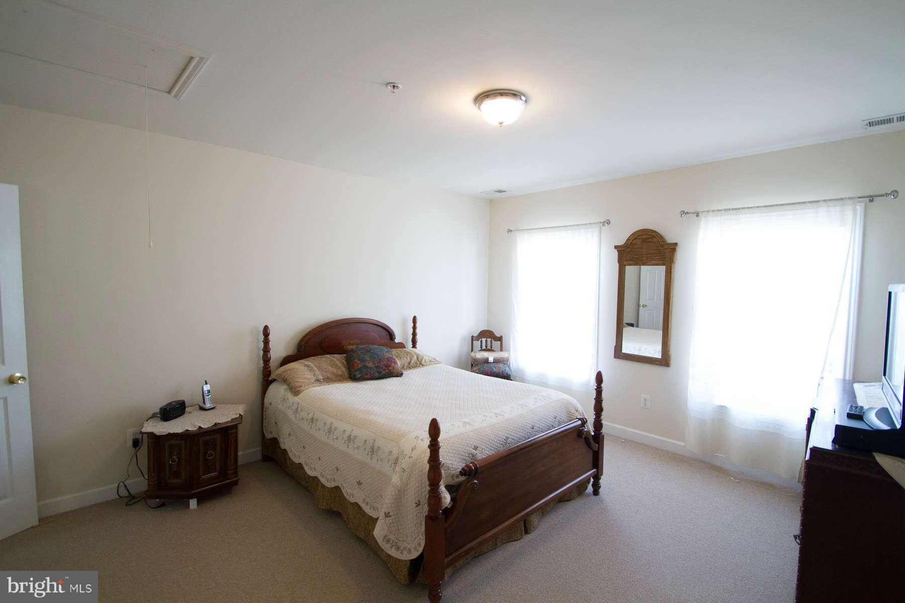 13609 Layhill Road Silver Spring, MD 20906 - Photo 25 of 30 a bedroom with a bed and a potted plant