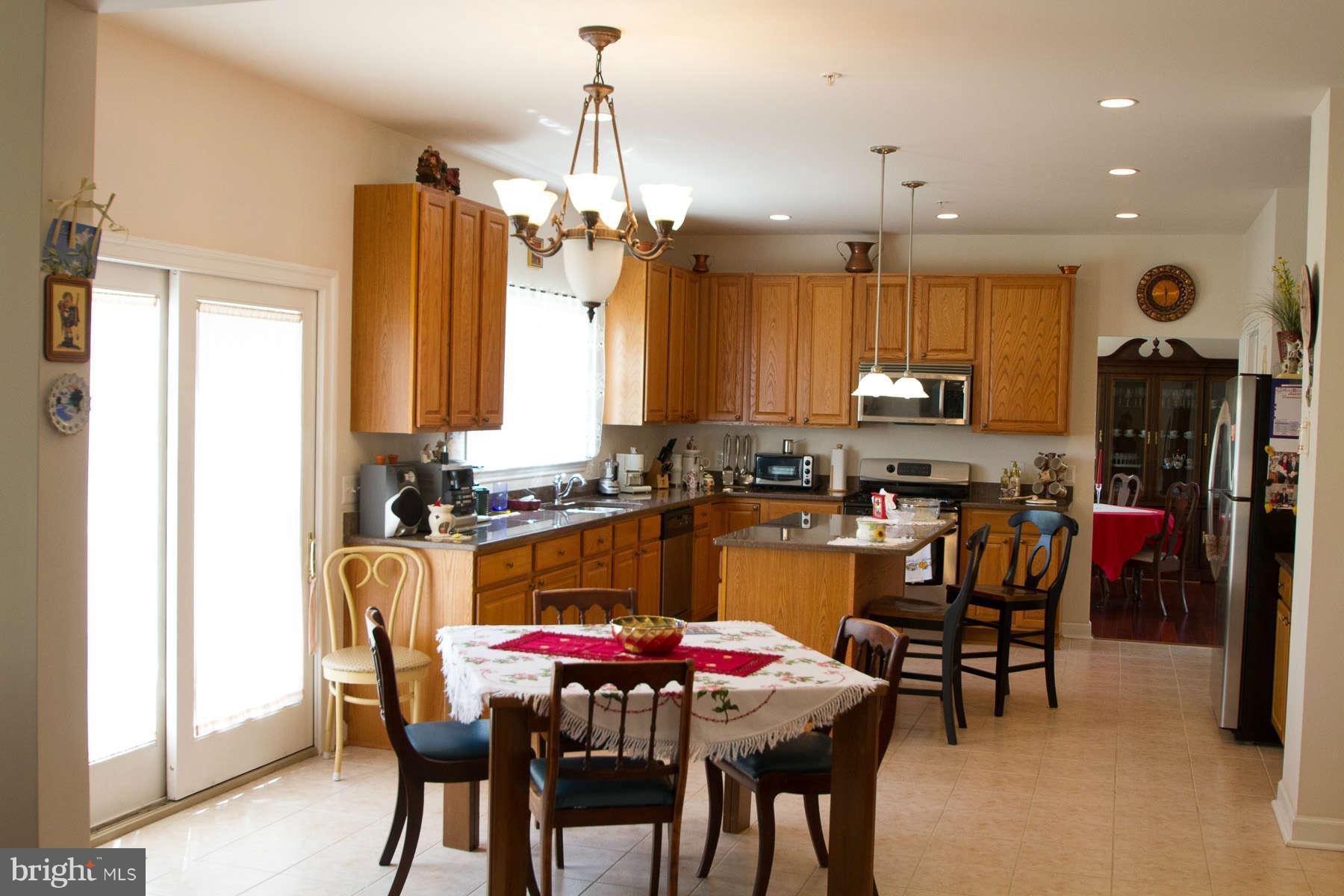 13609 Layhill Road Silver Spring, MD 20906 - Photo 7 of 30 a view of a dining room with furniture and chandelier