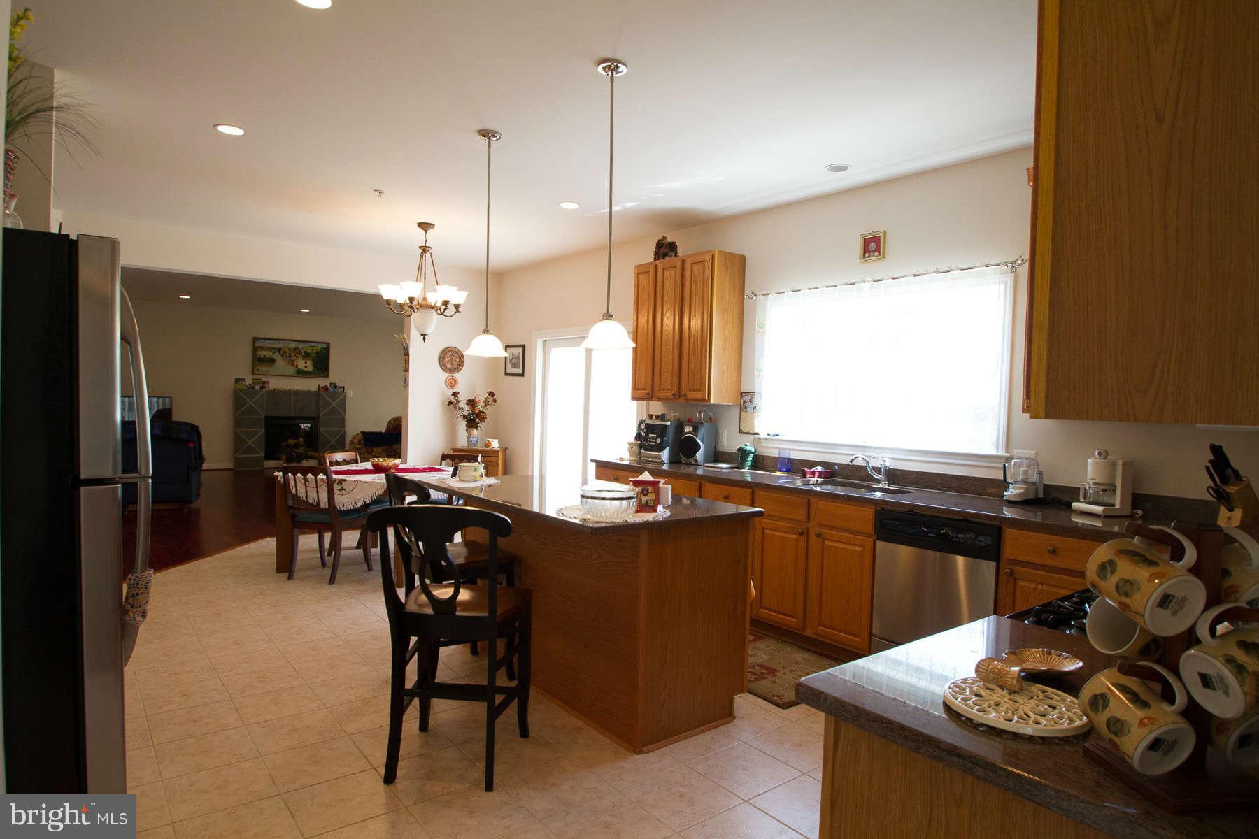 13609 Layhill Road Silver Spring, MD 20906 - Photo 8 of 30 a kitchen with a table chairs stove and refrigerator