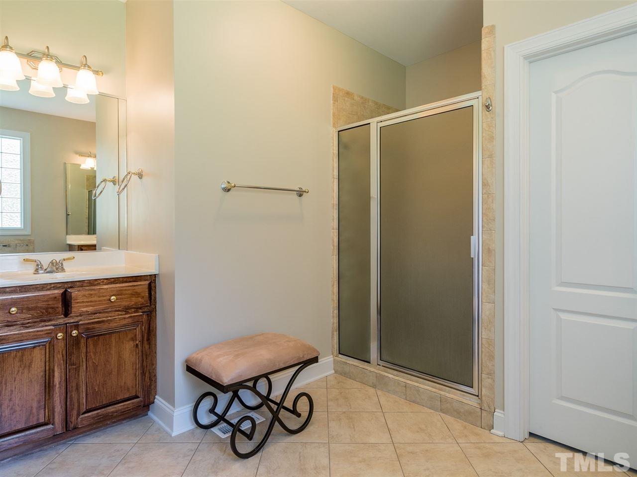 1025 Grissom Farm Road Garner, NC 27529 - Photo 17 of 30 There is a separate shower and tub in this wonderful space.