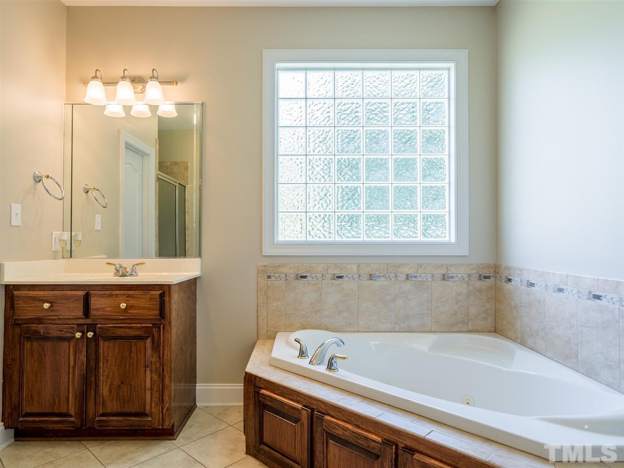 1025 Grissom Farm Road Garner, NC 27529 - Photo 18 of 30 The master suite also boasts a whirlpool tub. Enjoy a soak at the end of the day!