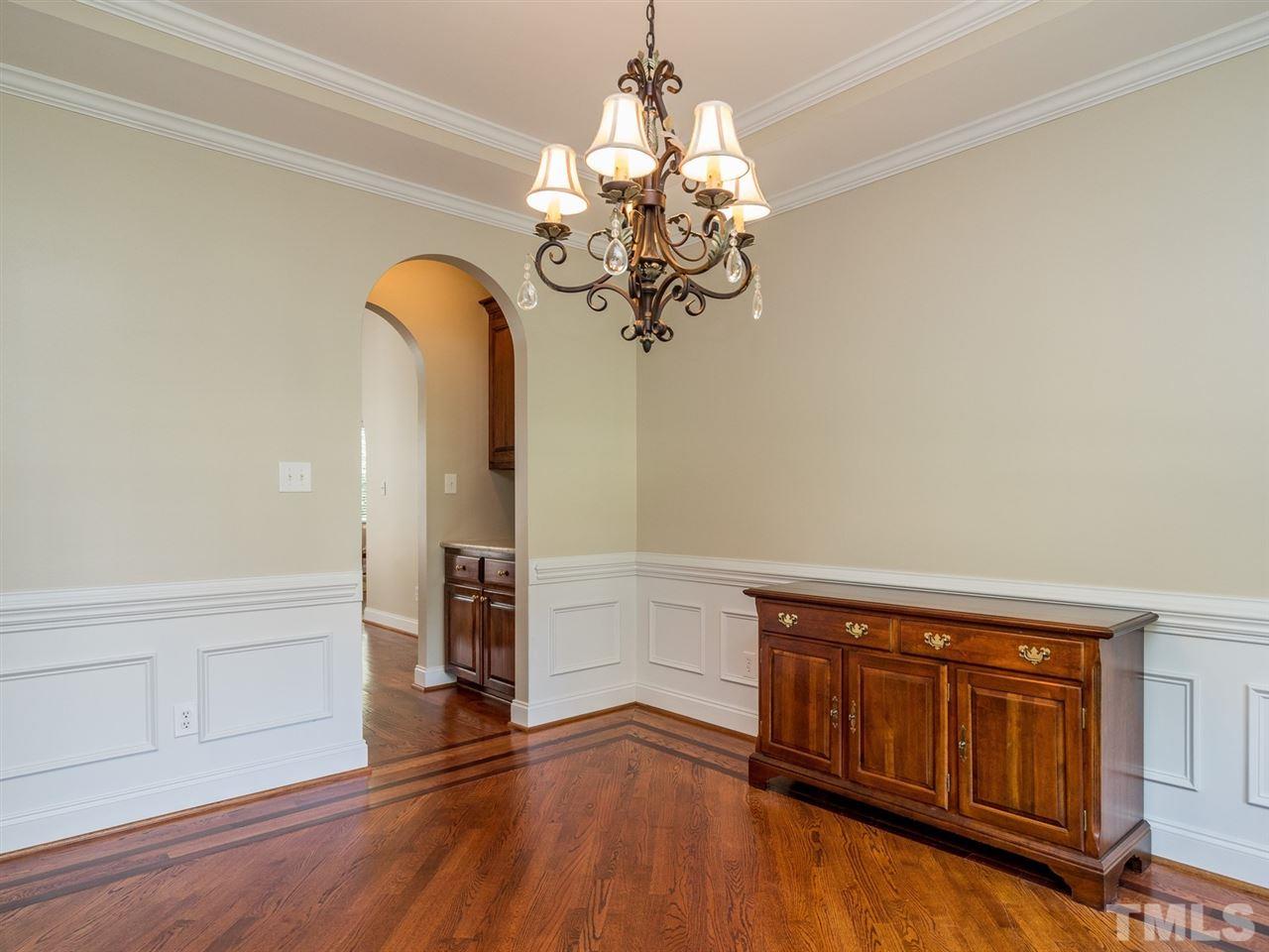 1025 Grissom Farm Road Garner, NC 27529 - Photo 6 of 30 Wainscoting and crown molding add to the elegant feel in this lovely room.